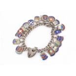 A silver and enamel charm/badge bracelet, the curb linked bracelet with heart shaped padlock