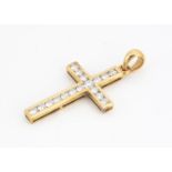 A continental yellow metal and diamond set cross pendant, the brilliant cuts in channel setting, all