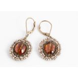 A pair of amber and seed pearl ear drops, oval shape centred with a faceted amber bead, surrounded