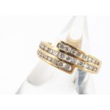 An 18ct gold three band brilliant cut diamond channel set ring, the brilliant cuts triple set bands,