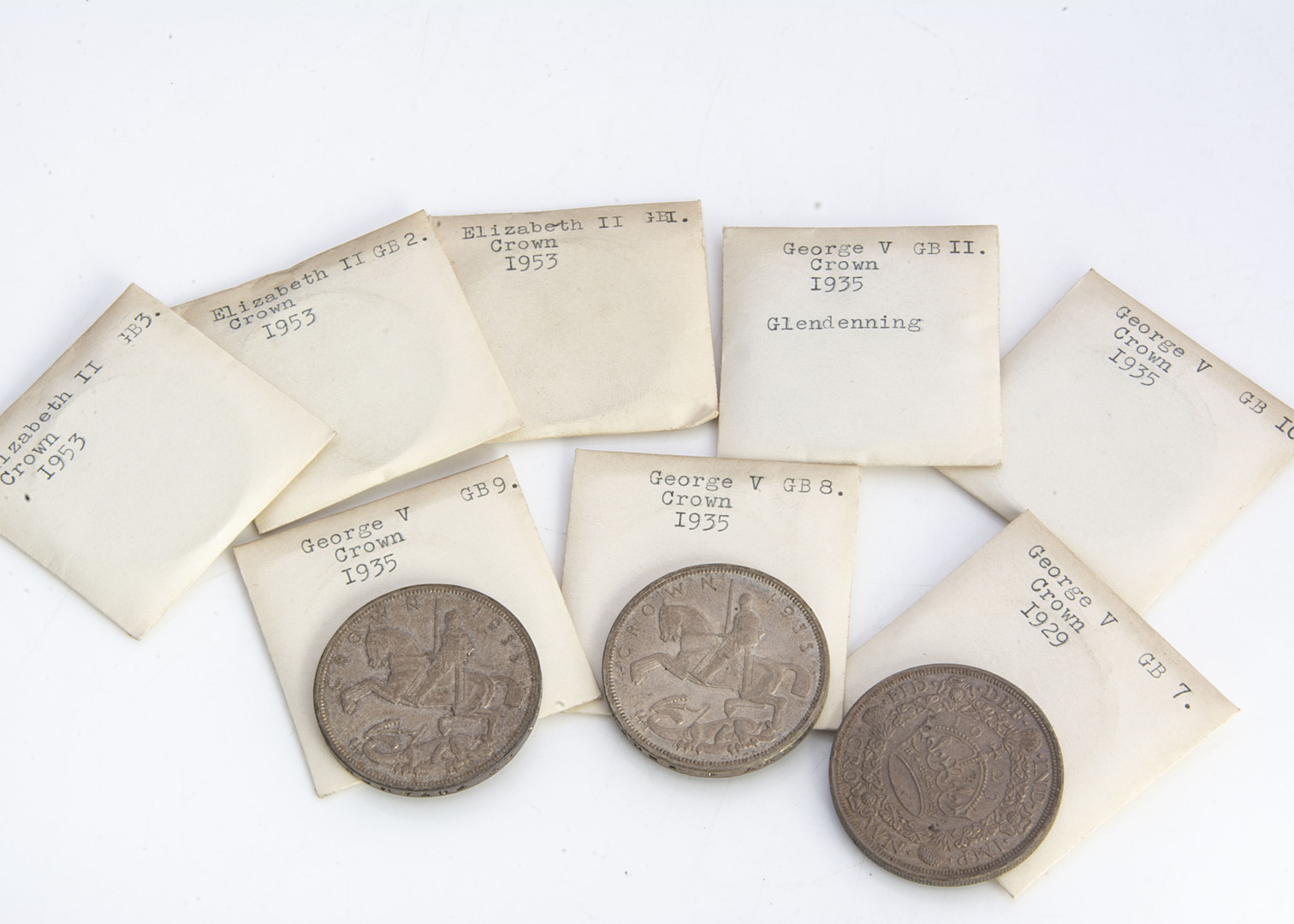 Five George V crowns, including a 1929, EF, and four from 1935, EF, along with three 1953 crowns (