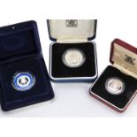 Three modern Royal Mint silver coins, including a 1986 £2, a 1982 piedfort 20p and a 1983 £1