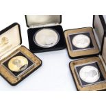 Four silver commemorative coins, incuding a large Jamaica $25, and three Bahamas $10, all boxed