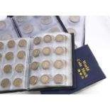 A large collection of British coins, presented in small coin albums, from George VI and Elizabeth