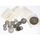 A small collection of British and other coins, including a worn William III crown, a worn 1822 crown