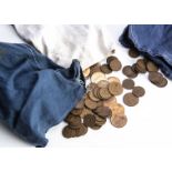 A collection of 20th century British pennies and half pennies, in three cloth money bags