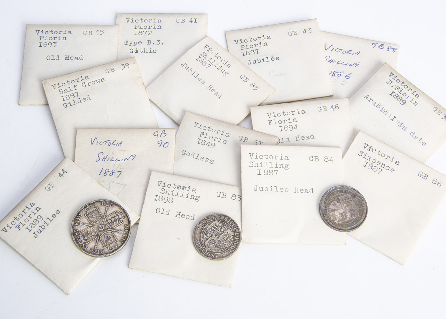 Fourteen Victorian silver coins, including an 1849 Godless florin, a gilt 1887 half crown, an 1886