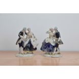 A pair of Royal Dux ceramic figural groups, both featuring a man and woman, marked to the bases,