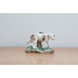 A turn of the century Meissen porcelain figurine of a German hound, in natural surroundings, the