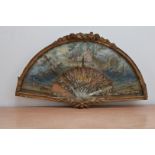 An 18th. Century paper fan, AF, in mother of pearl depicting classical scenes, in a glazed gilt