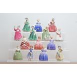 14 Royal Doulton ceramic figurines, including three figurines of Marie H.N. 1370, Babie H.N. 1679,