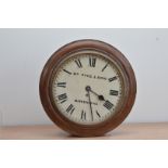 A late 19th/early 20th century circular mahogany cased wall clock, the dial inscribed Wm. Pyke &