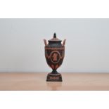 A 20th century Wedgwood Jasperware twin handled lidded urn, terracotta and black 'Vase 40', with