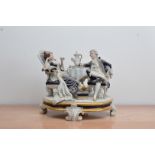 A large Royal Dux ceramic figural group, of a couple relaxing having afternoon tea, marked to the