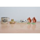 A collection of Derby porcelain items and others, comprising a reclining Greyhound on a