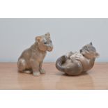 Two Royal Copenhagen porcelain figurines of lion cubs, one playing and biting his foot 14cm wide and