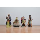 Four Royal Doulton ceramic figurines, comprising Blue Beard H.N. 2105, Cobbler H.N. 1706, Town Crier