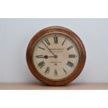 A late 19th/early 20th century circular oak cased wall clock, the dial inscribed Camerer, Cuss & Co.