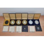 Six cased 20th century Wedgwood Jasperware plaques of members of the Royal Family, all with