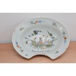 A late 18th century French faience barber bowl, hand painted design, the middle depicting three