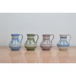 Four 20th century Wedgwood Jasperware jugs, in four different colours; blue, green, pink and