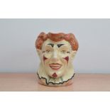 A Royal Doulton character jug of The Clown, with a white face and brown hair, marked to the base,