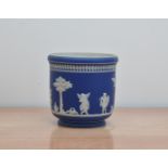 A mid to late 19th century Jasperware vase, blue base design, with small children, marked 'C' to the