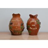 Two French late 19th century terracotta named and dated jugs, dated 1886 and 1878, 22cm & 20.5cm