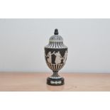 A 1970's Wedgwood Jasperware Dancing Hours lidded urn, black and white design, the lid with acorn