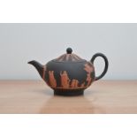 A 20th century Wedgwood Jasperware Terracotta and black teapot, limited edition of 500 in gold on