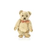 A rare Steiff small sized Jackie teddy bear 1953, with pale golden mohair, clear and black glass