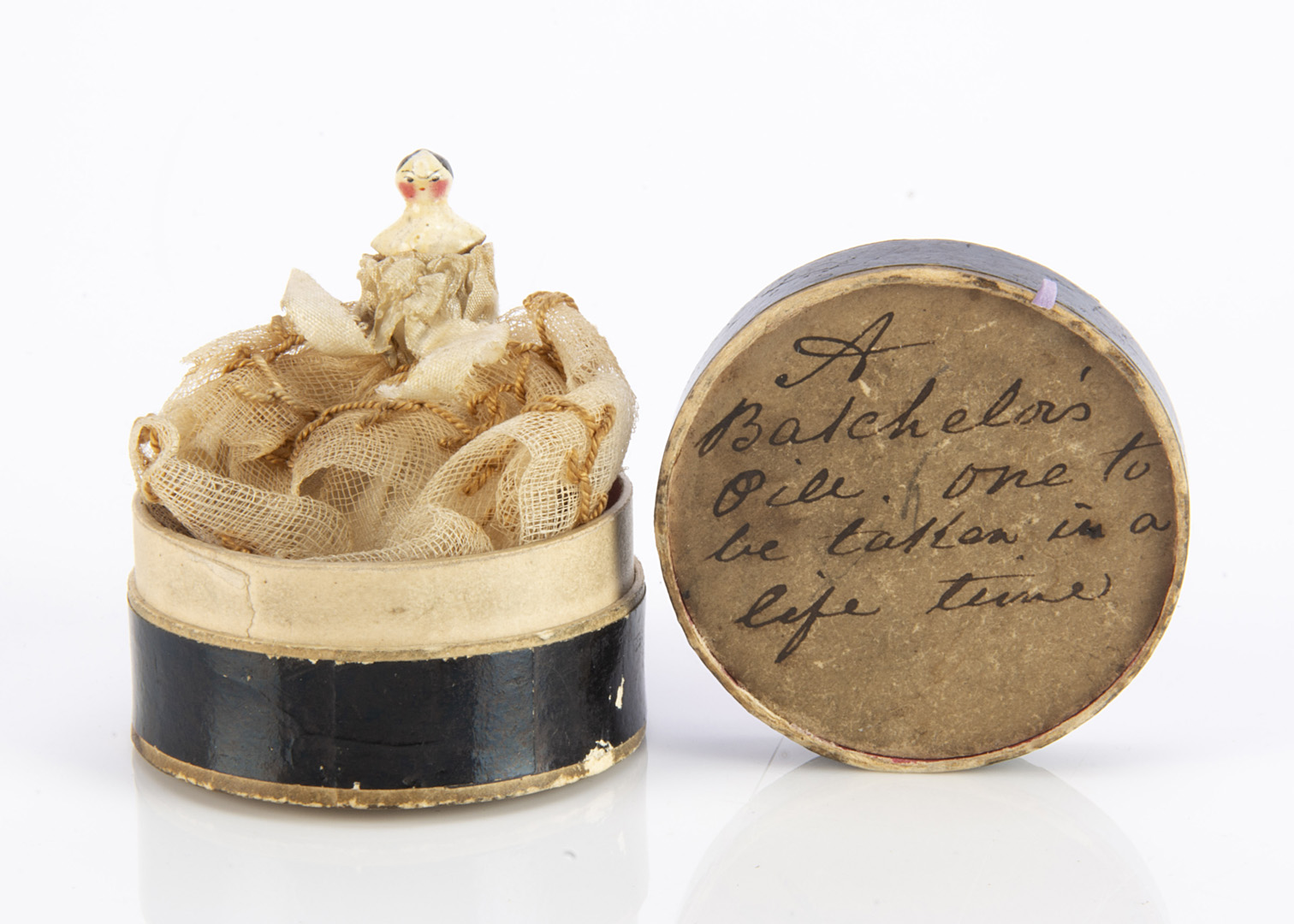 A Batchelor’s Pill One to be Taken in a Life Time, a circular cardboard pill box with handwritten