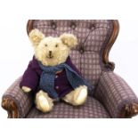 A 1940s teddy bear, with beige mohair, clear and black glass eyes, slight pronounced muzzle, black