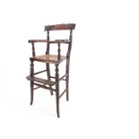 An early 19th century faux rosewood child's highchair, with fluted carved back rest, bobbin turned