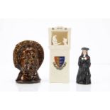 Three porcelain novelties, a German candlesnuffer of a priest or judge --3¼in. (8cm.) high; a 19th