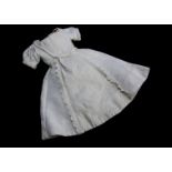 A mid 19th century style Enfantine doll’s dress, of ribbed cotton, low neckline and embroidered
