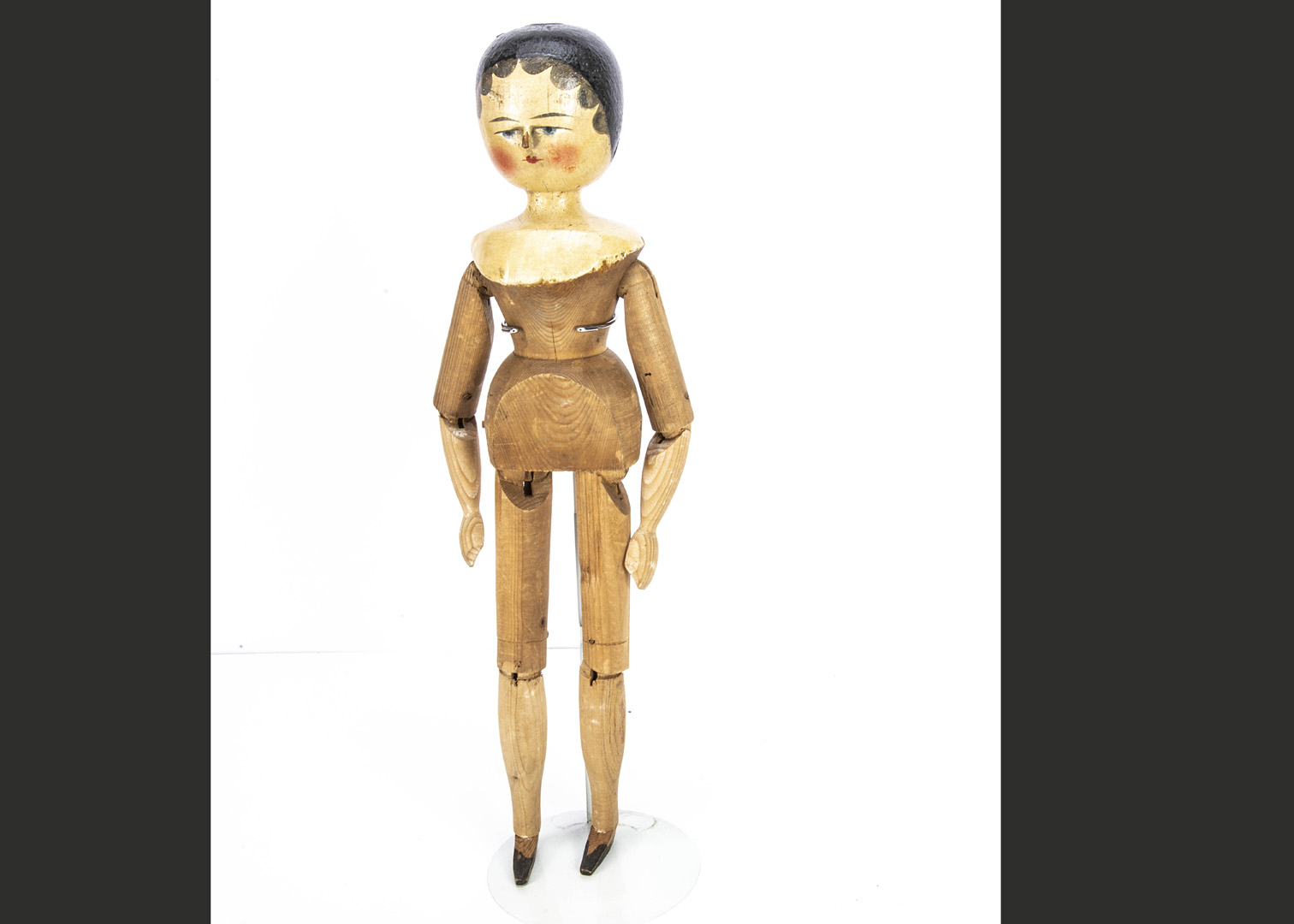 A last quarter of the 19th century German turned and painted pegged-wooden doll, with blue painted