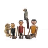 Three British turned wooden jigging figures, a man and a woman with round heads, painted features