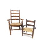 A child's country ladder back chair, with rush seat --29¾in. (76cm.) high; and a smaller oak chair