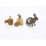 Three novelty tape measures, a brass rabbit with steel egg shaped body —2¼in. (5.5cm.) long; a