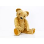 A fine 1930s Merrythought teddy bear, with bright golden mohair, orange and black glass eyes,