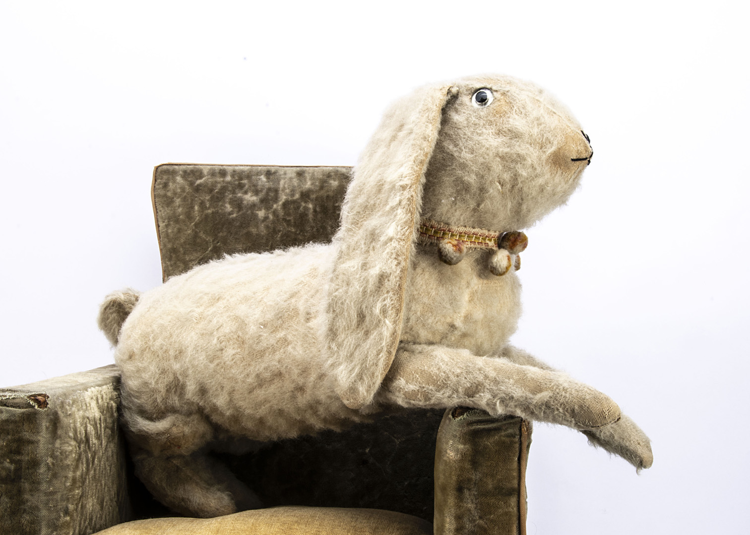 A large British running rabbit, probably 1930s, with white wool plush, clear and black glass eyes,