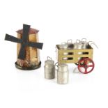 A German Penny Toy windmill sweet dispenser, lithographed tinplate with working sails and sliding