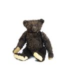 A very rare Steiff black mohair teddy bear circa 1912, with black boot button eyes, red felt discs