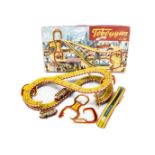A Technofix No.290 Toboggan Tinplate Clockwork Toy, comprising colourful elevated track, two cars,