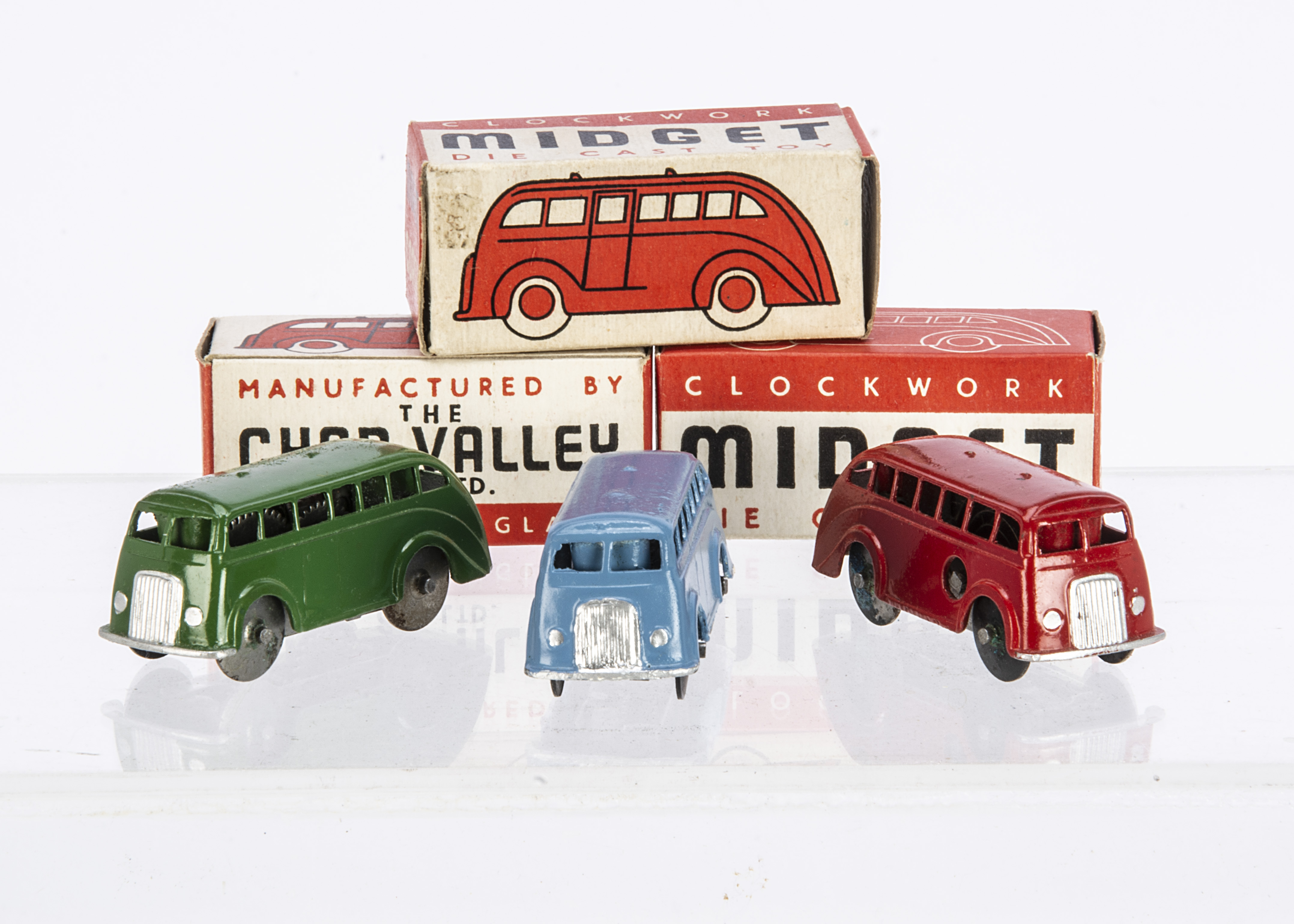 Chad Valley Clockwork Diecast Midget Coaches, three examples, green, red, light blue, in original