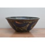 A large studio pottery glazed earthenware bowl by Richard Phethean, blue and orange decoration on