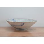 A large modern studio pottery porcelain bowl by J. Howells, blue swirl with Swan decoration on a