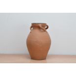 A 20th century terracotta vase, with three spiral handles, internally glazed, the rim painted in