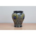 An early 20th century Moorcroft pottery baluster vase, c. 1916, with Peacock feather pattern,